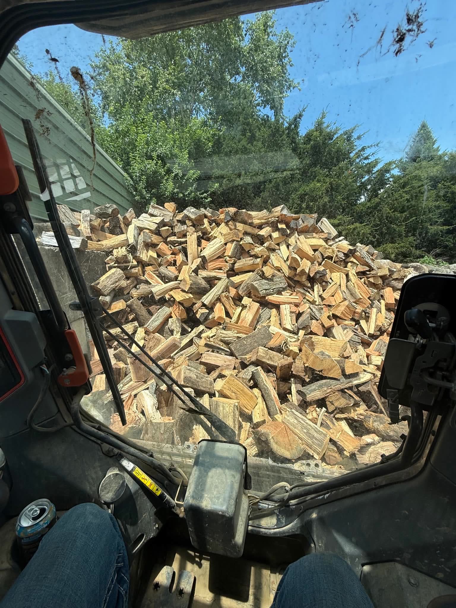 A dump bed filled with freshly split firewood
